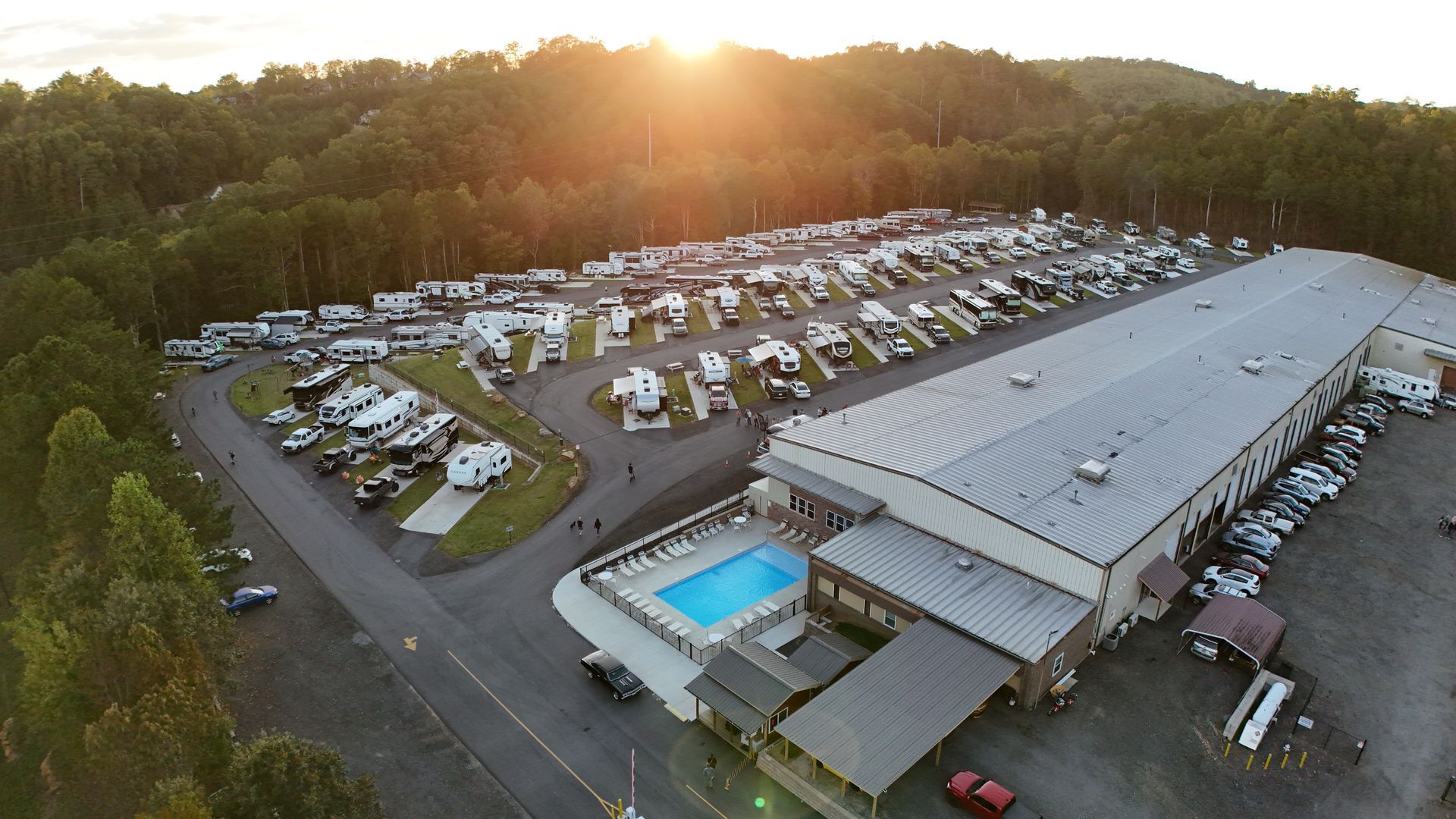 An aerial view of a city surrounded by trees and buildings on a sunny day.