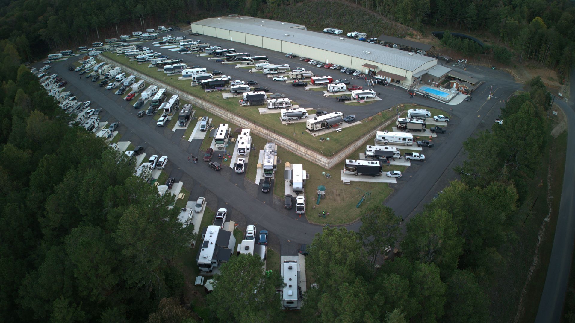 A rv is driving down a road in the mountains.