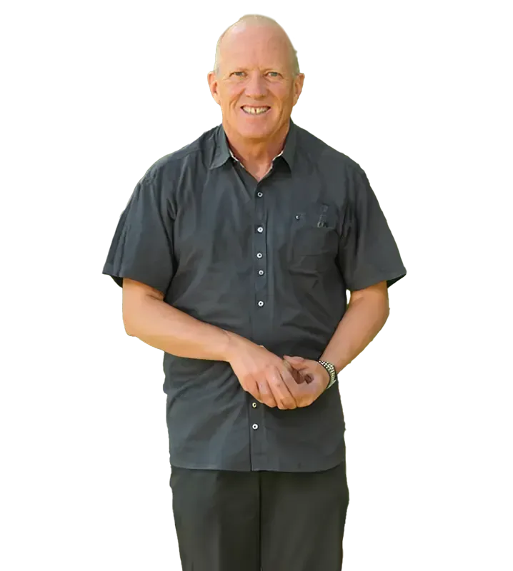 A man in a black shirt and black pants is smiling