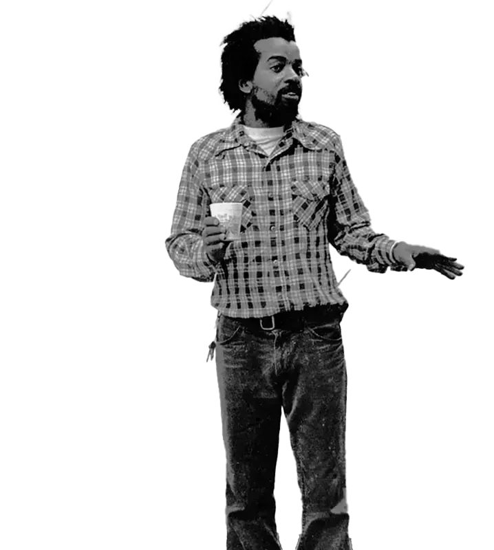 A man in a plaid shirt is holding a cup of coffee