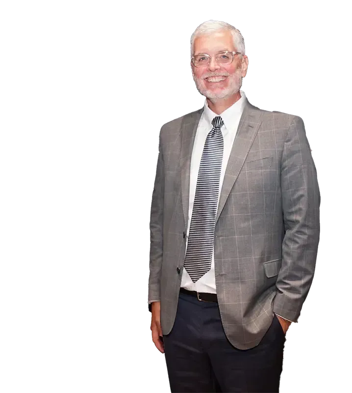 A man in a suit and tie with his hands in his pockets