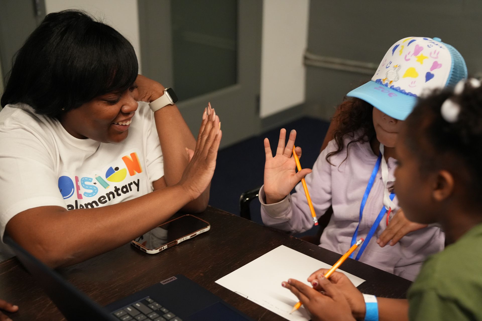 Boy with headphones gasps while looking at a laptop on a blue couch near a window.