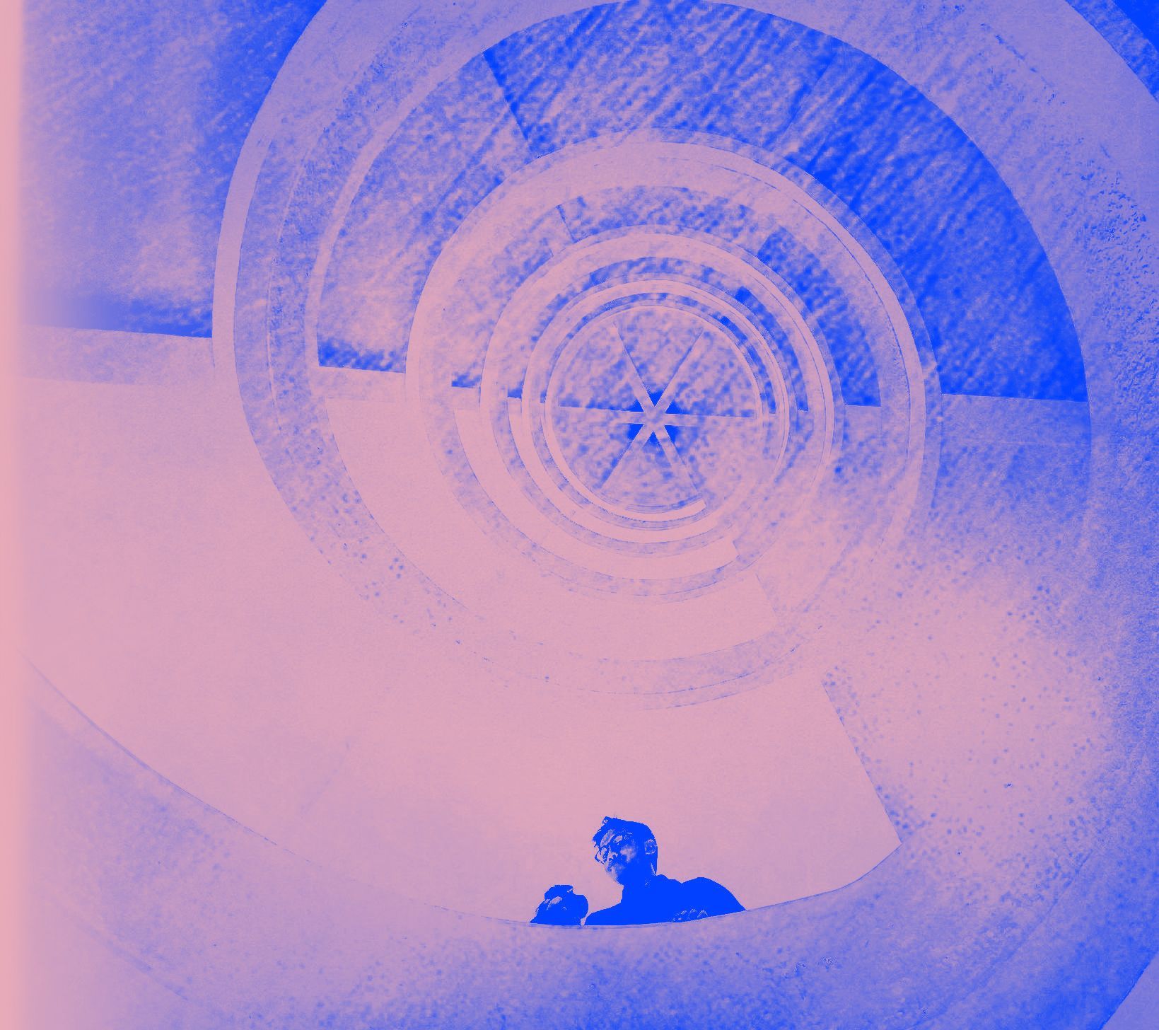 An employee for Ascent Grace Digital that does Social Media Ads is standing in the middle of a spiral staircase.