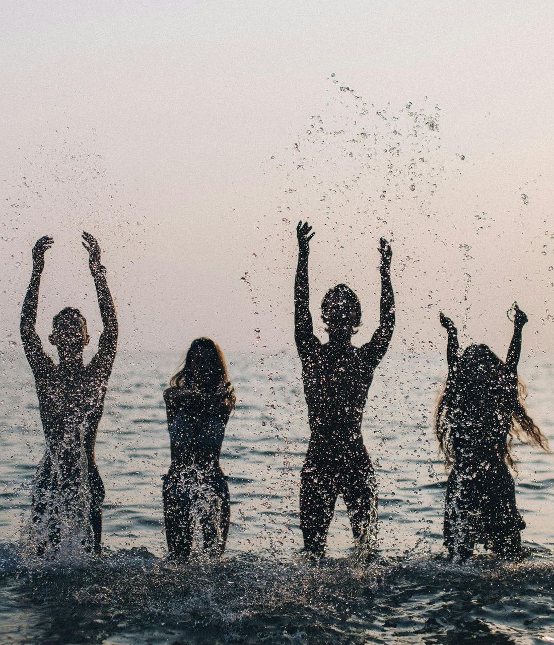 A group of people arms in the air, in ocean, Google ads.