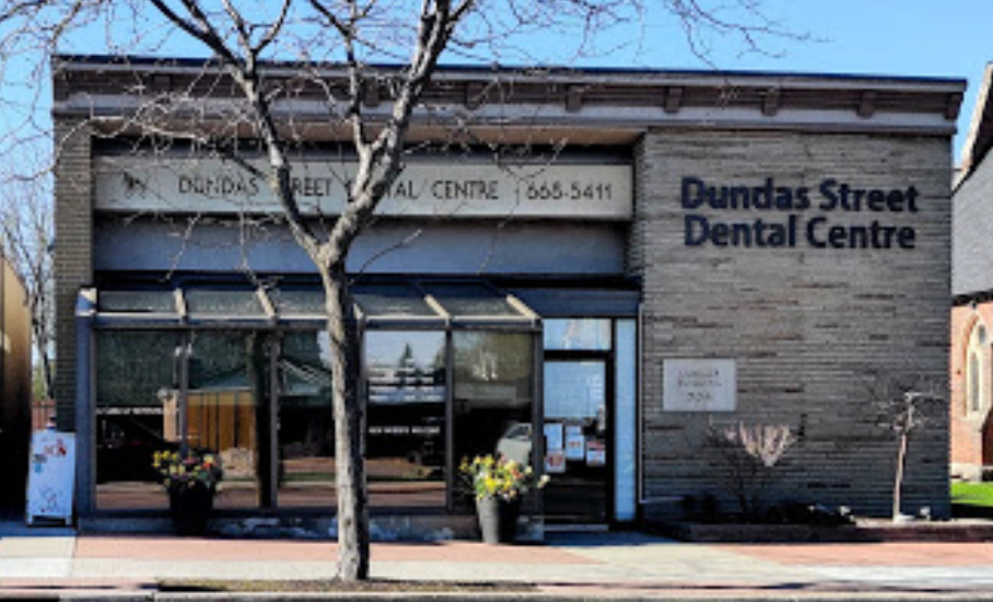 A group of women in blue scrubs are posing for a picture