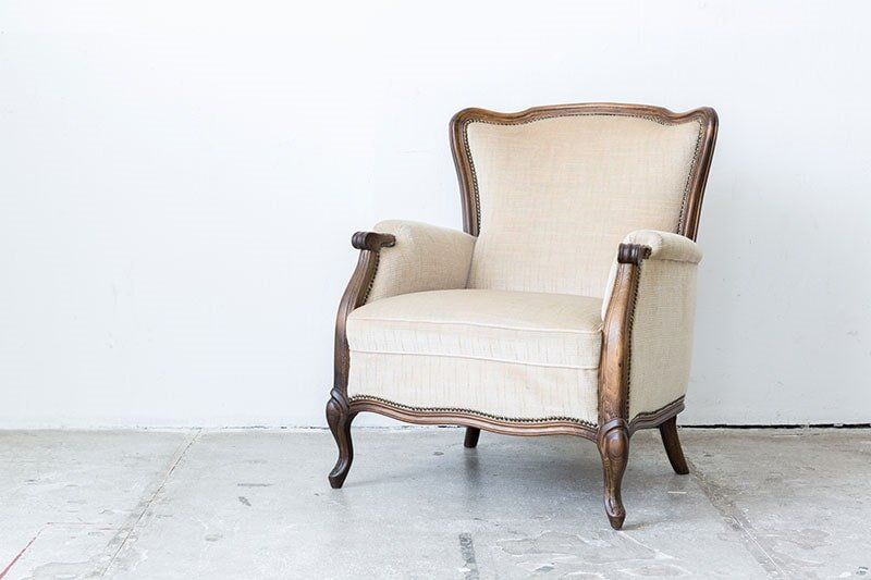 Cream Colored Chair with White Wall — Fabric Showroom in Groton, CT