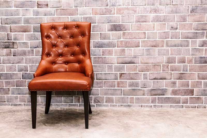 Upholstery Chair with Brick Wall — Fabric Showroom in Groton, CT