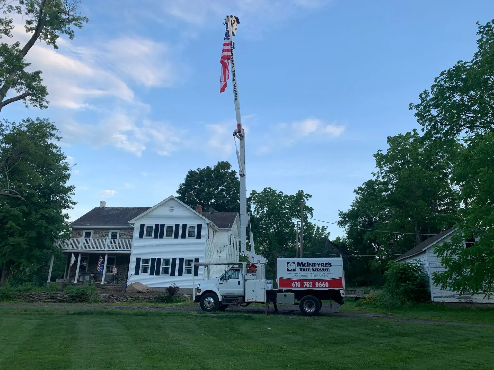 A white truck is parked in front of a house