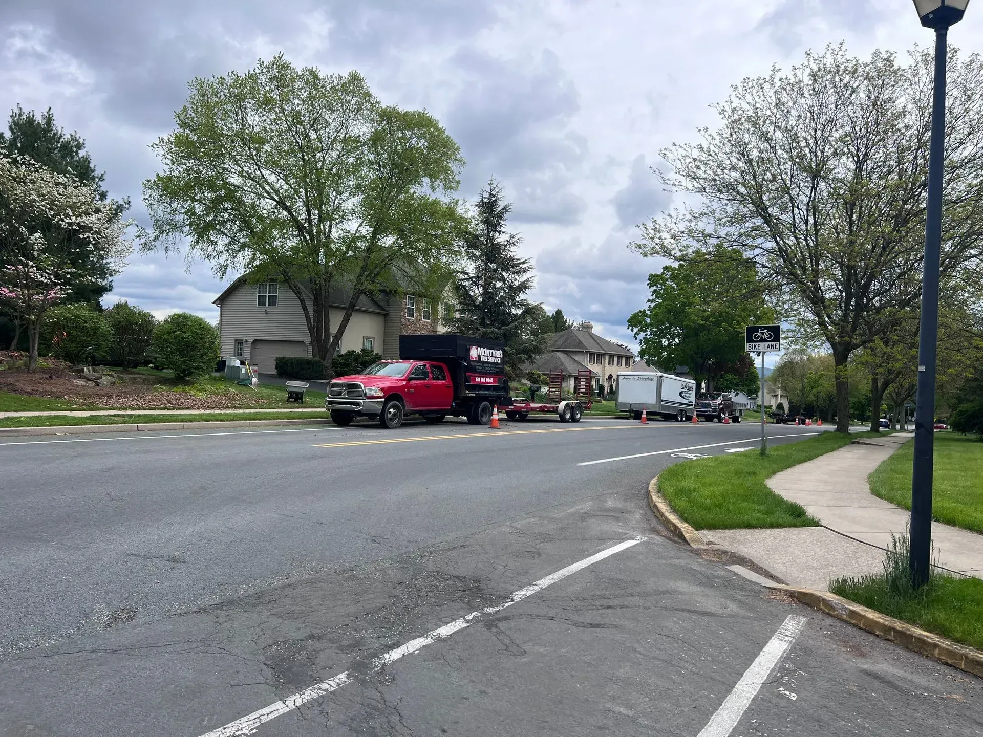 A red fedex truck is driving down a street