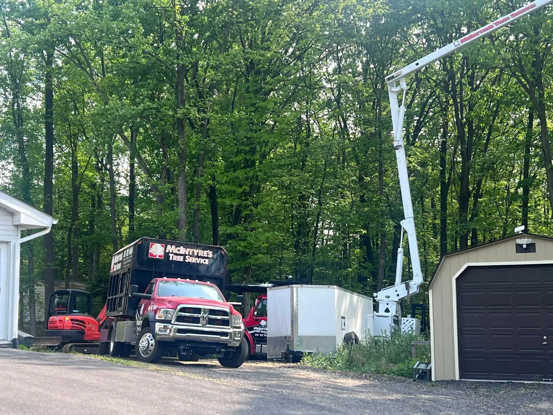A red truck is parked in front of a garage.