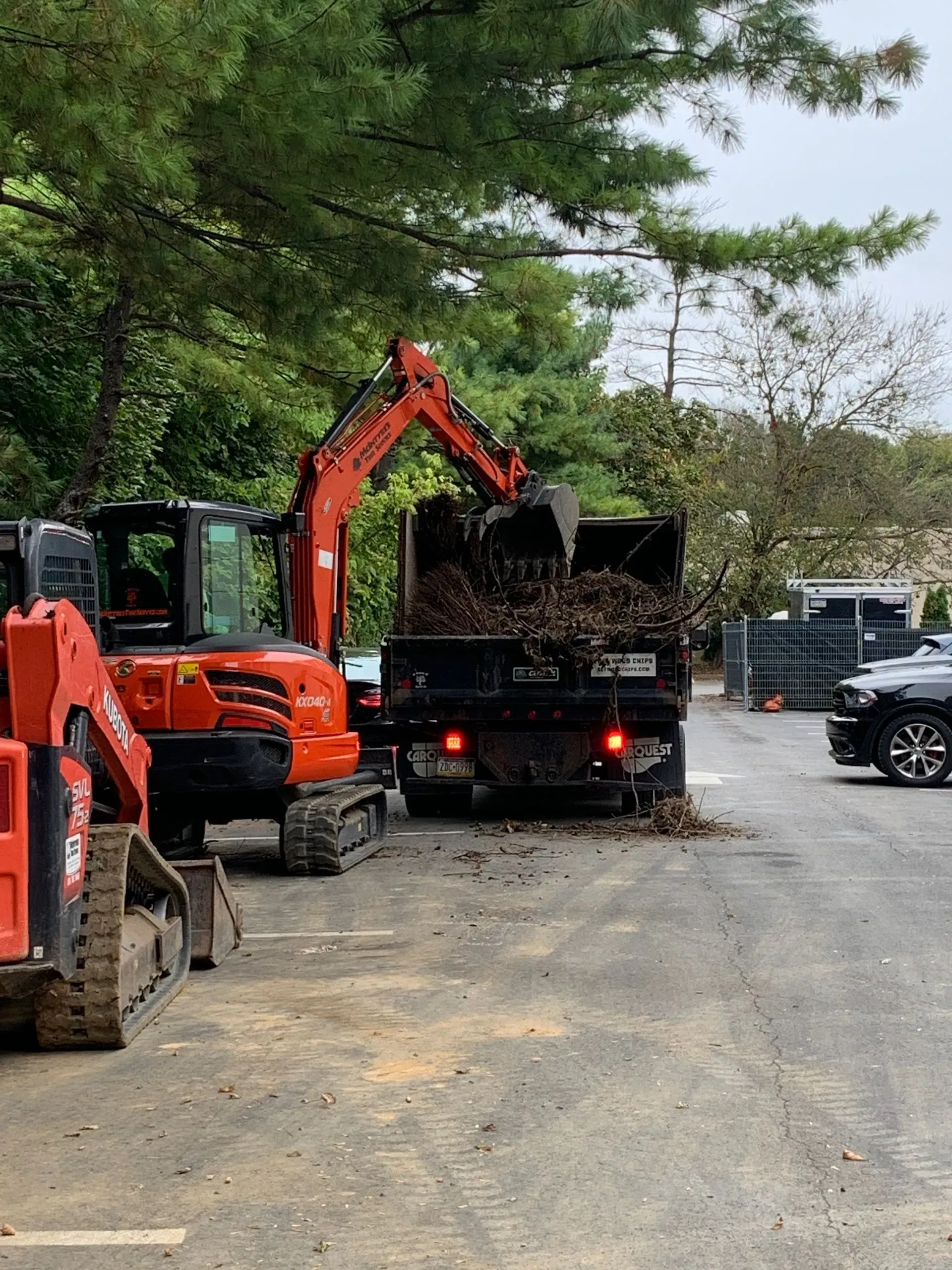 An excavator is loading a dump truck with dirt.