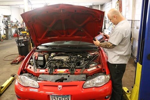 Man Doing Auto Inspection — Minneapolis, MN — Wallace Auto Parts & Repair