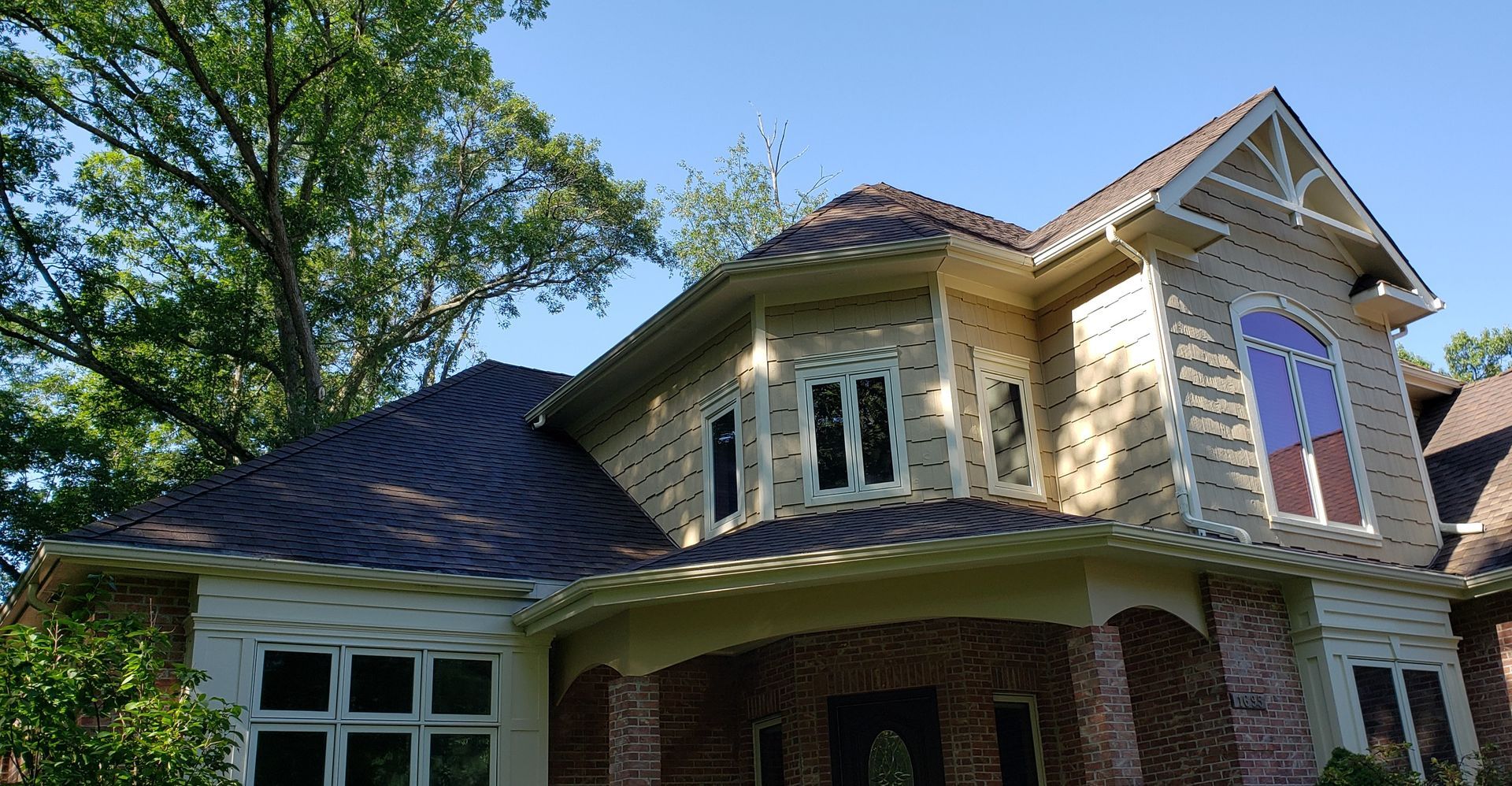 A large brick house with a red white and blue window