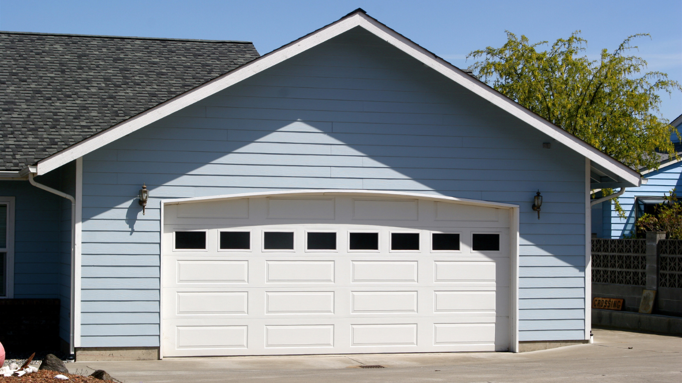 A blue house with a white garage door