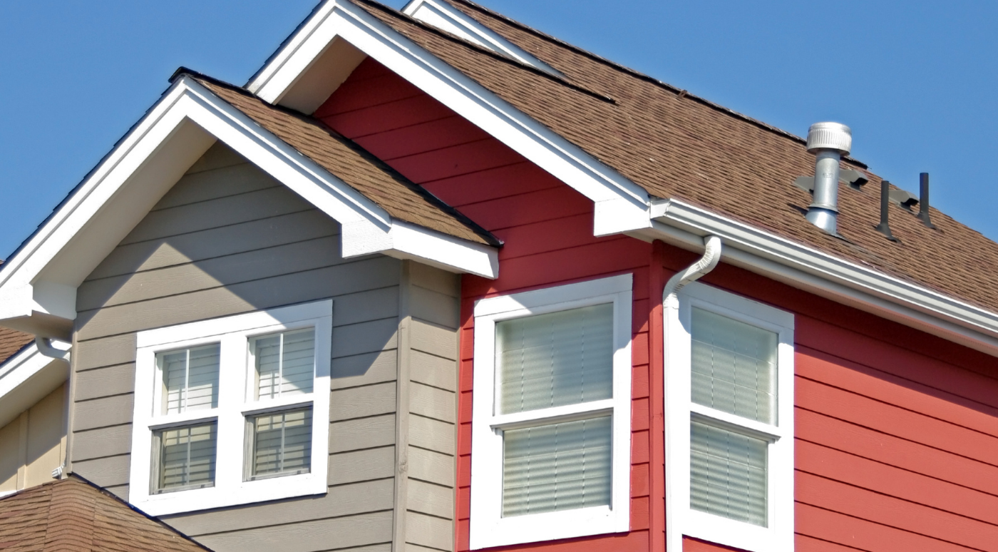 A red and gray house with a brown roof