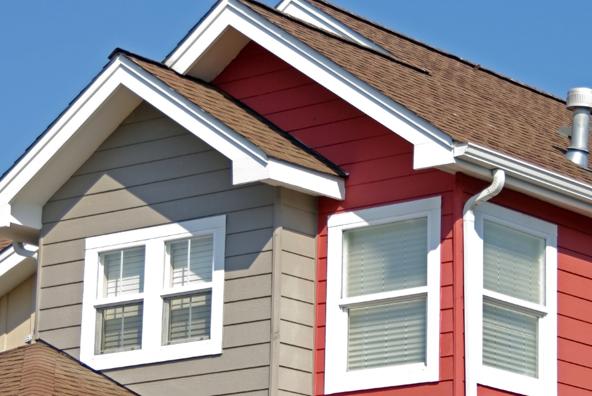 A red and gray house with a brown roof