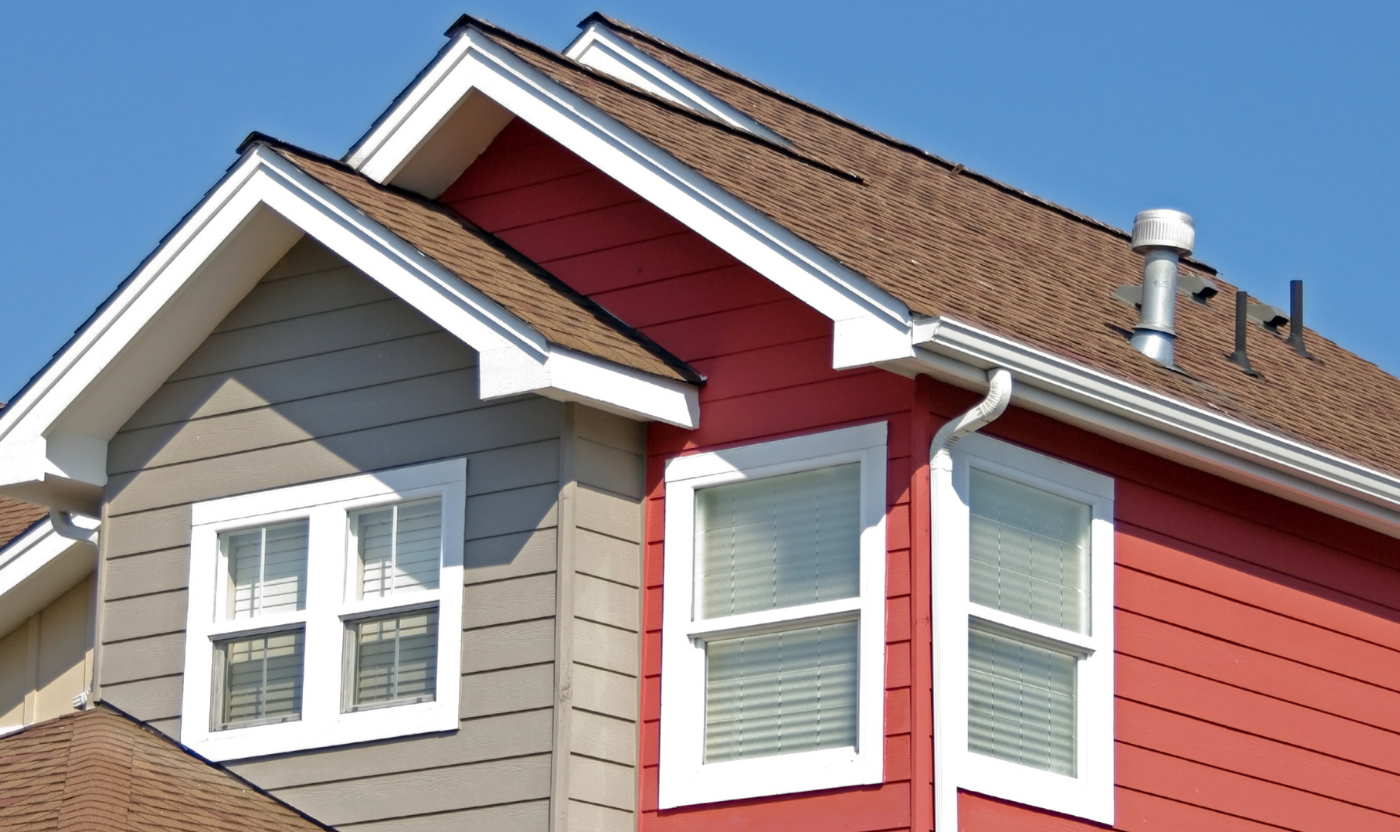 A red and gray house with a brown roof