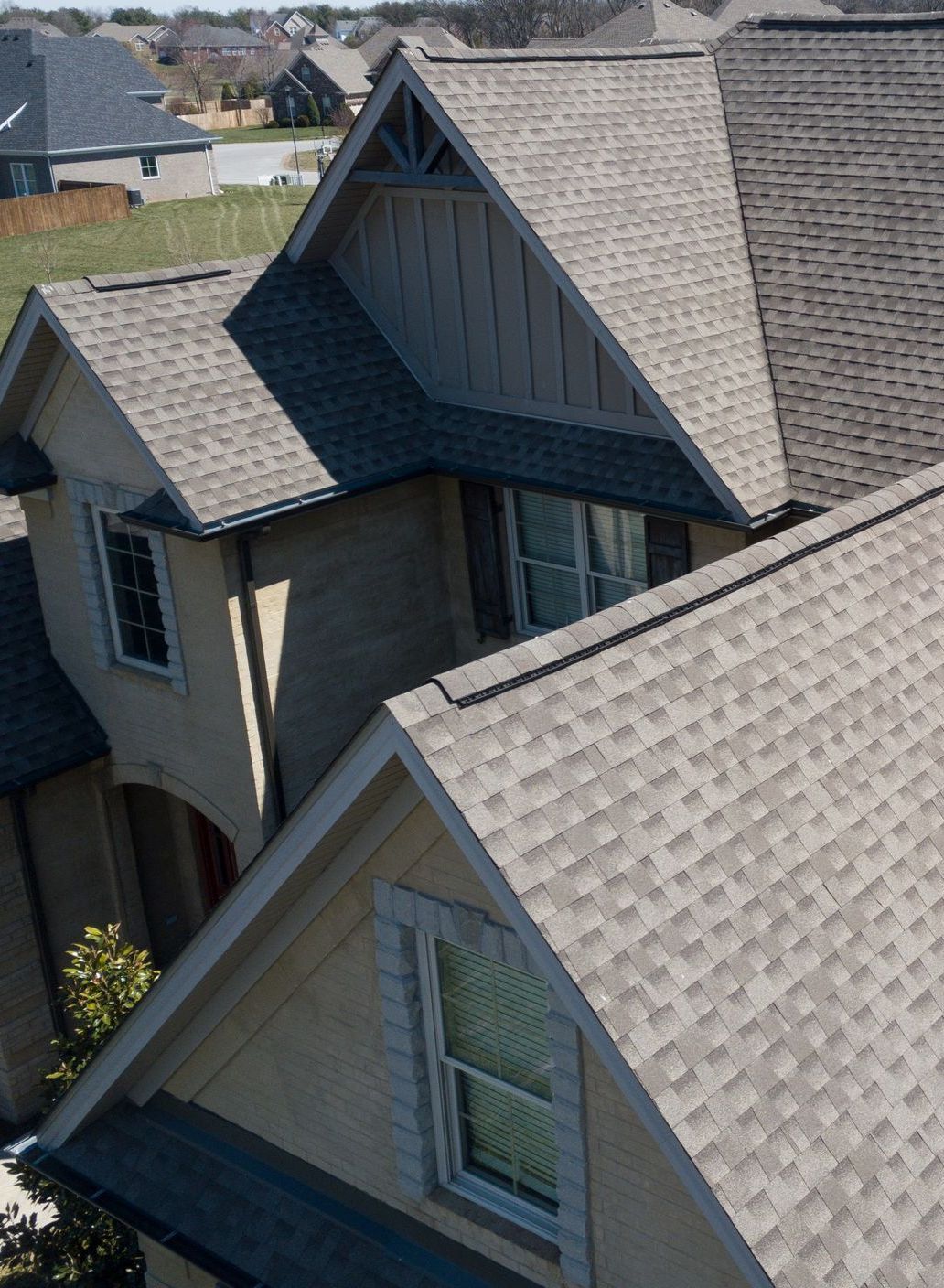 An aerial view of a house with a gray roof