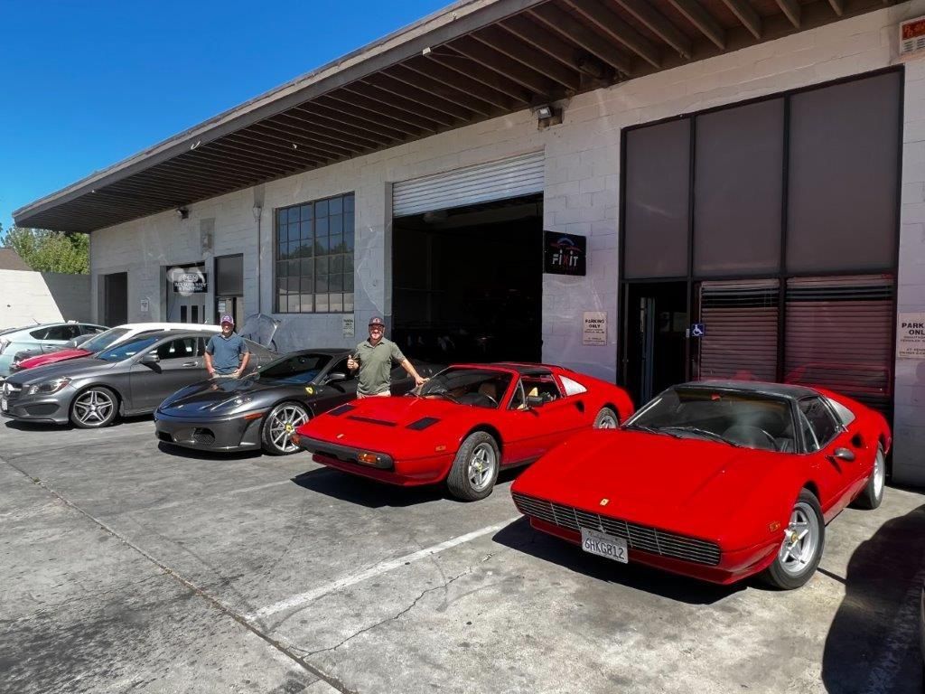 A group of cars are parked in front of a building.