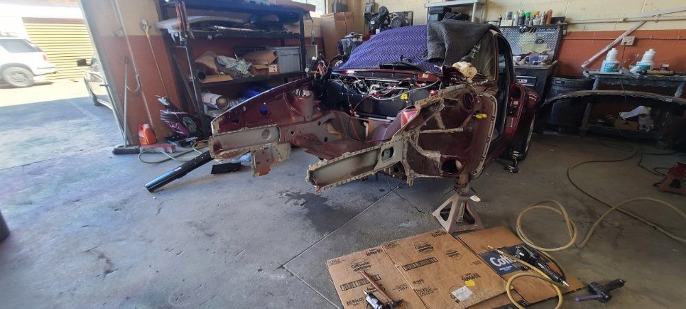 A car is being worked on in a garage.