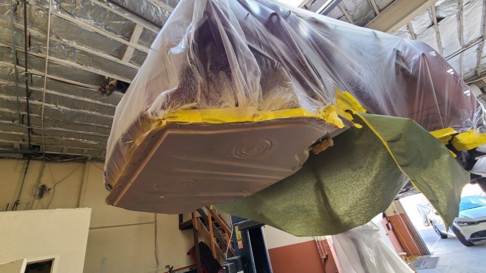 A large piece of plastic is hanging from the ceiling of a building.