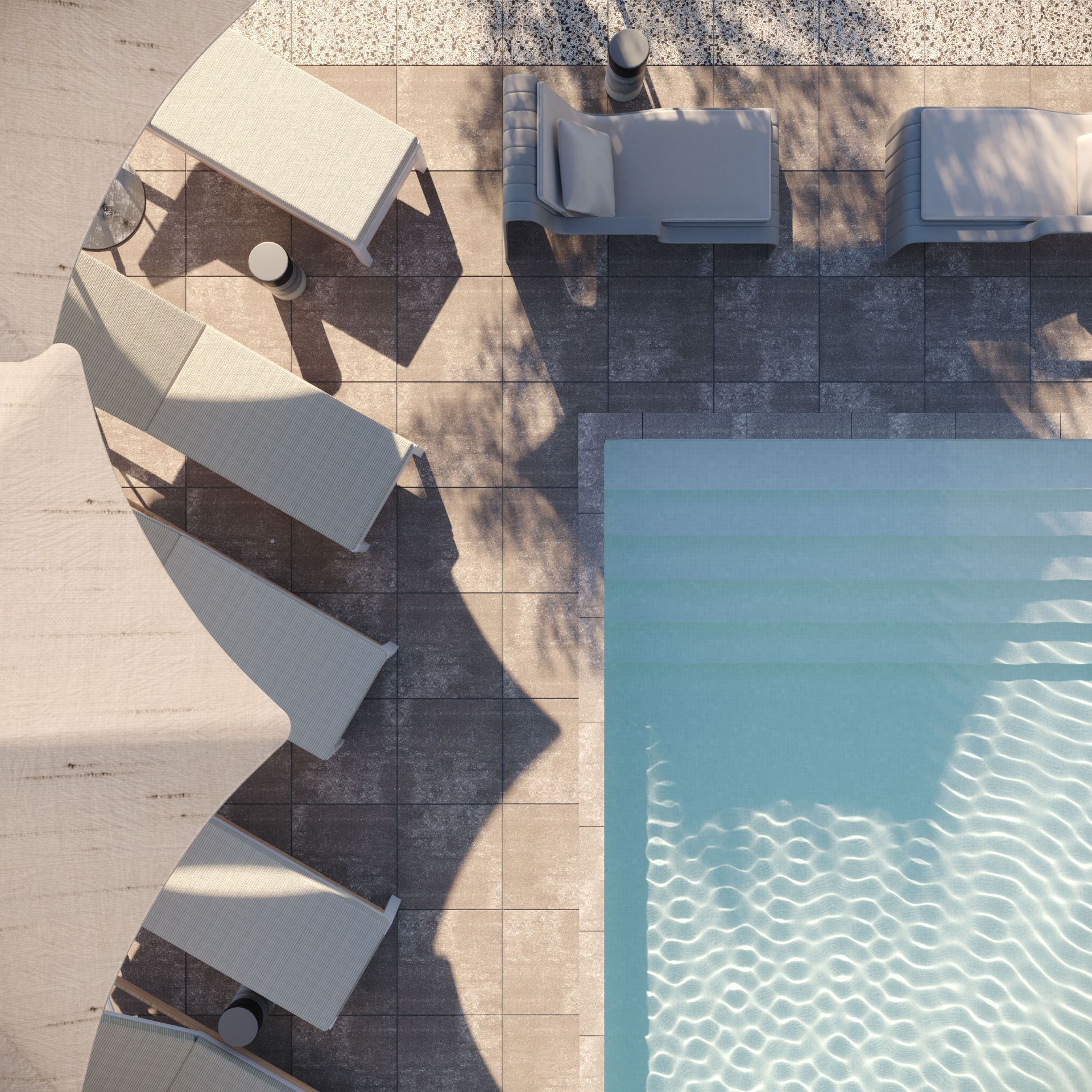 Aerial view of a poolside deck with lounge chairs, umbrellas, and a turquoise swimming pool.
