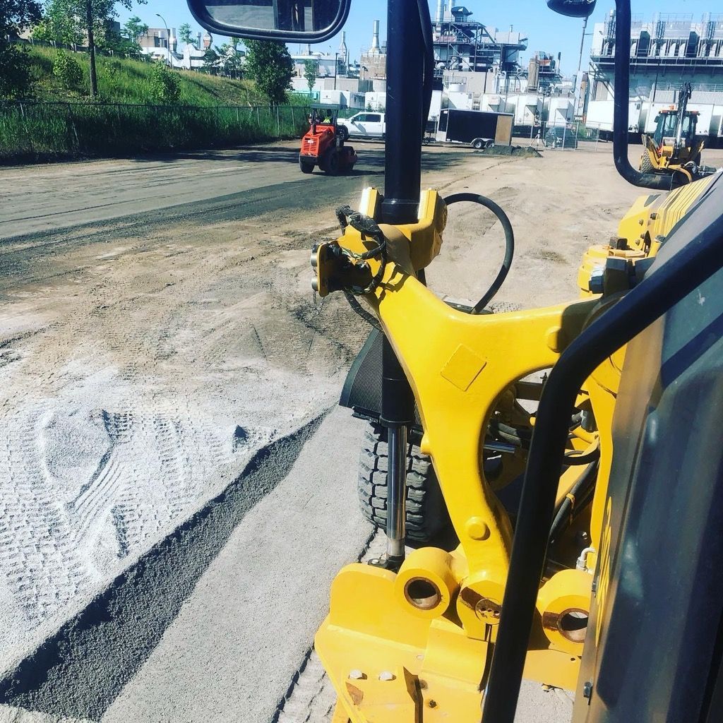 Un bulldozer jaune travaille sur un chemin de terre