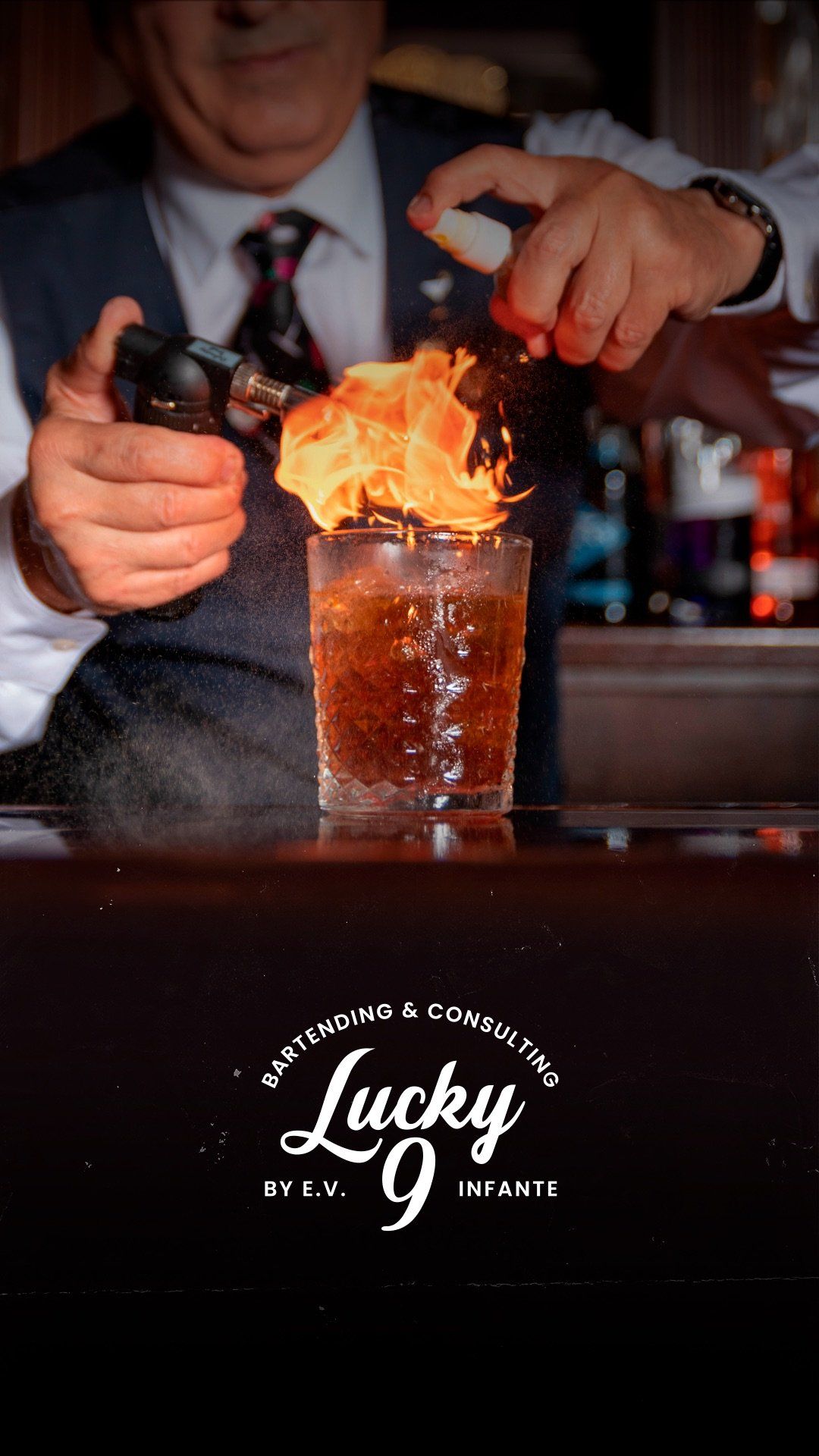 A man is pouring fire into a glass of beer.