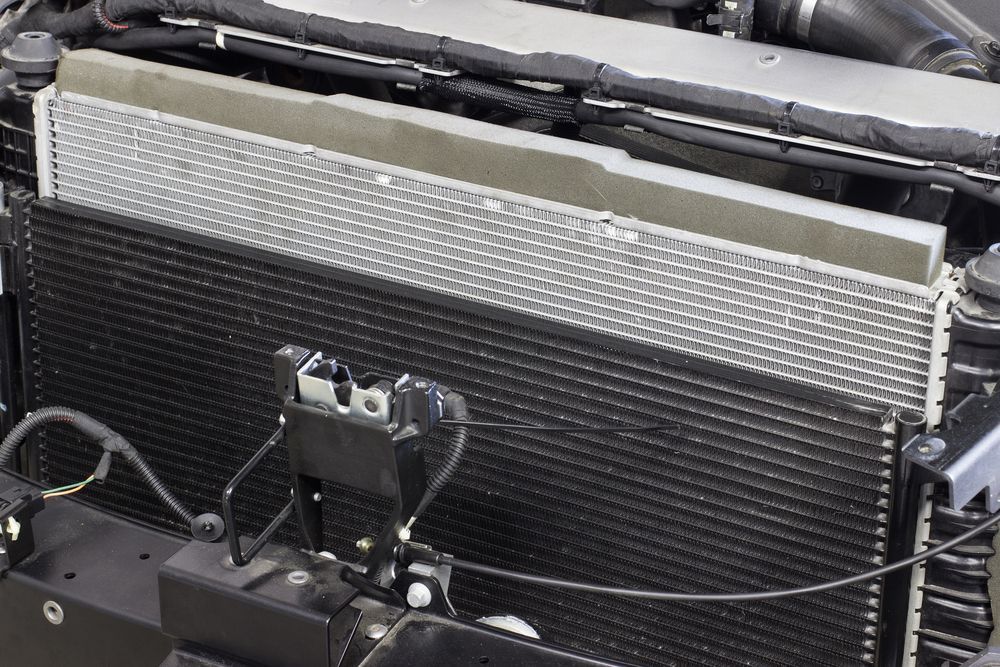 Car engine's radiator and condenser assembly; metallic silver and black components — P.K. Head Servicing & Reconditioning in Warilla, NSW