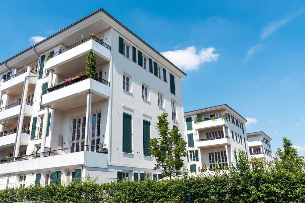 White Apartment Buildings With Balconies, Green Shutters — Curtis Strata in Woolgoolga, NSW