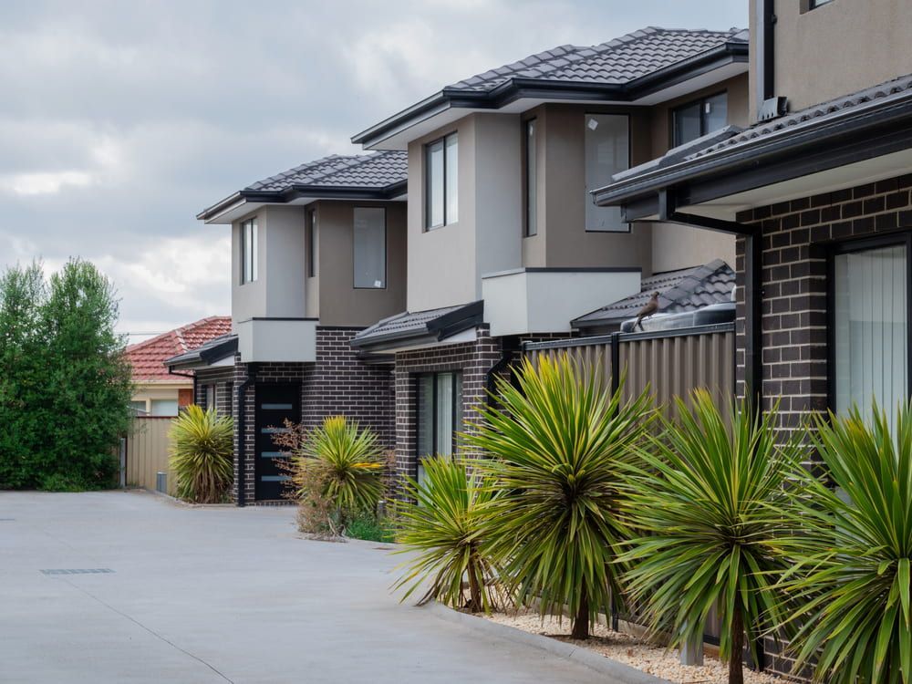 Row of Modern Townhouses With Beige and Brick Facades — Curtis Strata in Lismore, NSW