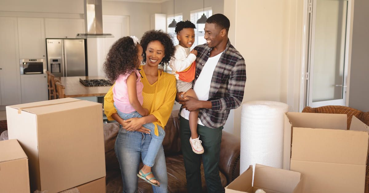 Diverse happy family moving into rental home