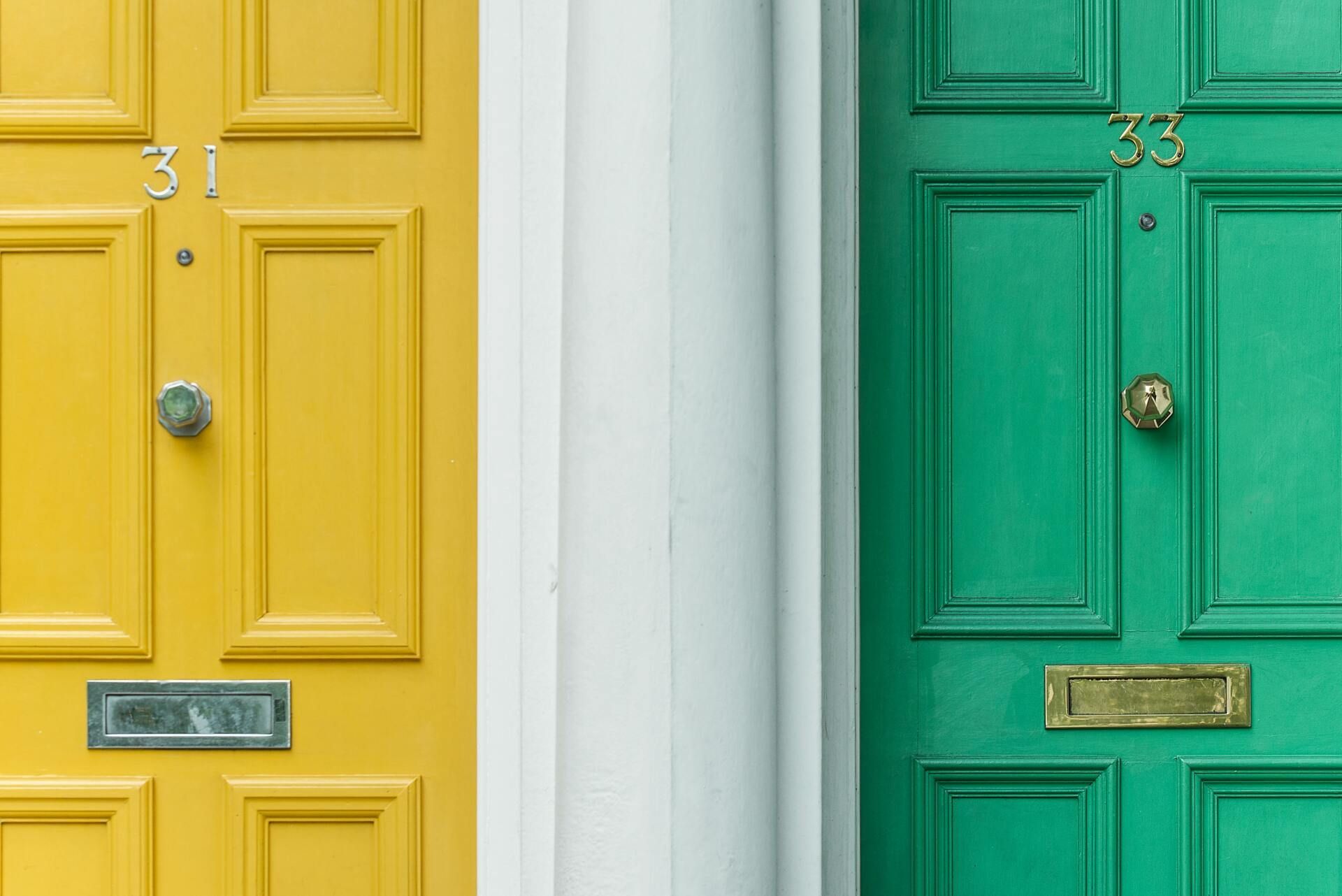 A yellow door and a green door are next to each other.