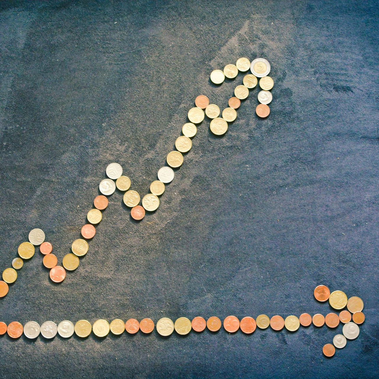 Image of upward arrow chart made out of pennies