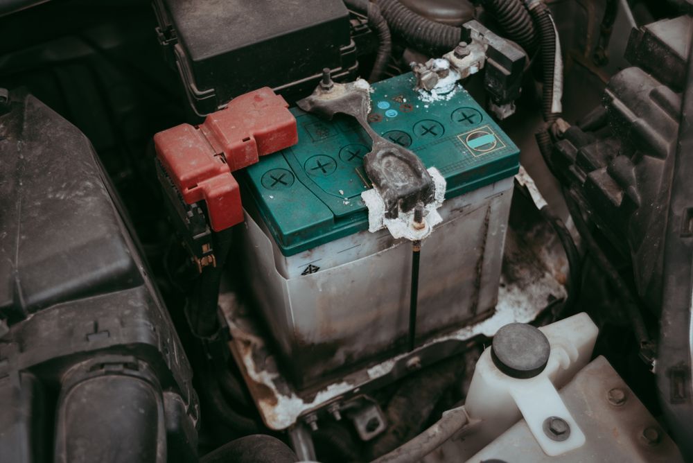 Car Battery in Engine Compartment With Corrosion and Red Positive — Independent Scrap Metal Pty Ltd in South Lismore, NSW