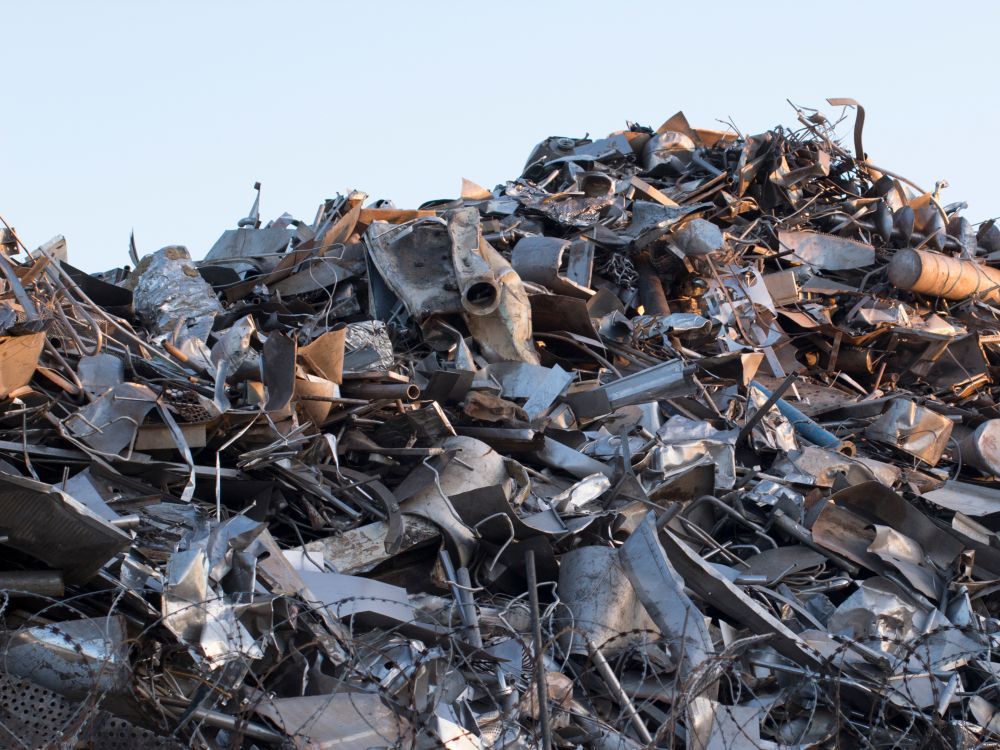 Pile of Scrap Metal, Including Car Parts, Against a Light Blue Sky — Independent Scrap Metal Pty Ltd in Grafton, NSW