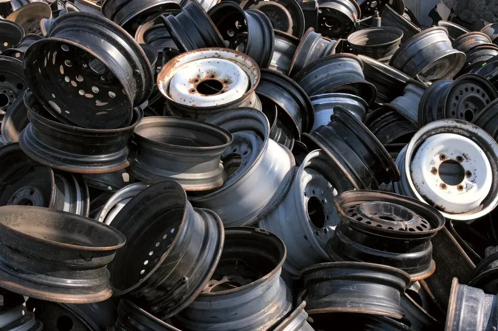 Pile of Discarded Black and White Car Rims — Independent Scrap Metal Pty Ltd in Casino, NSW