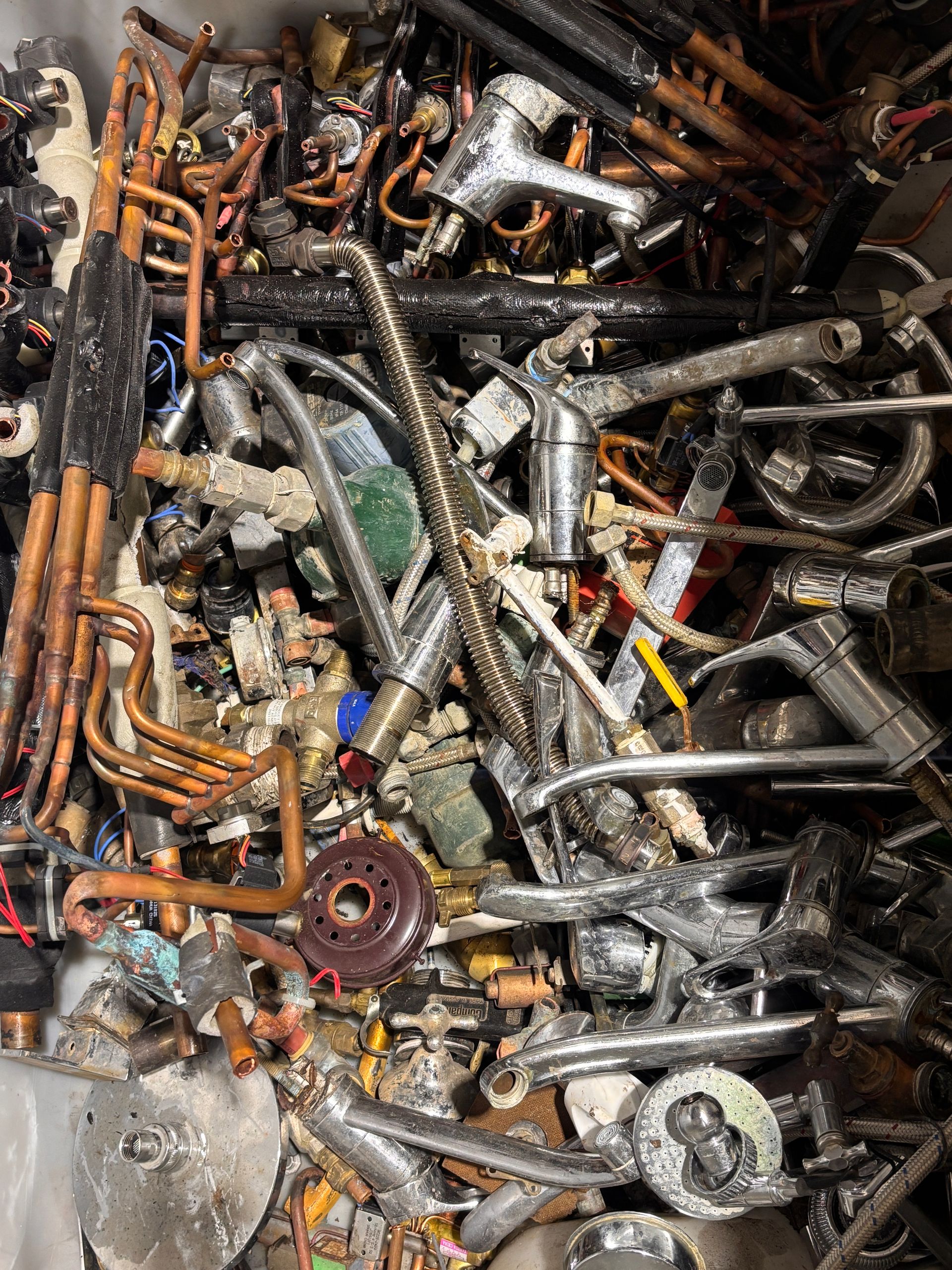 Pile of scrap metal including copper pipes and faucet handles— Independent Scrap Metal Pty Ltd in South Lismore, NSW