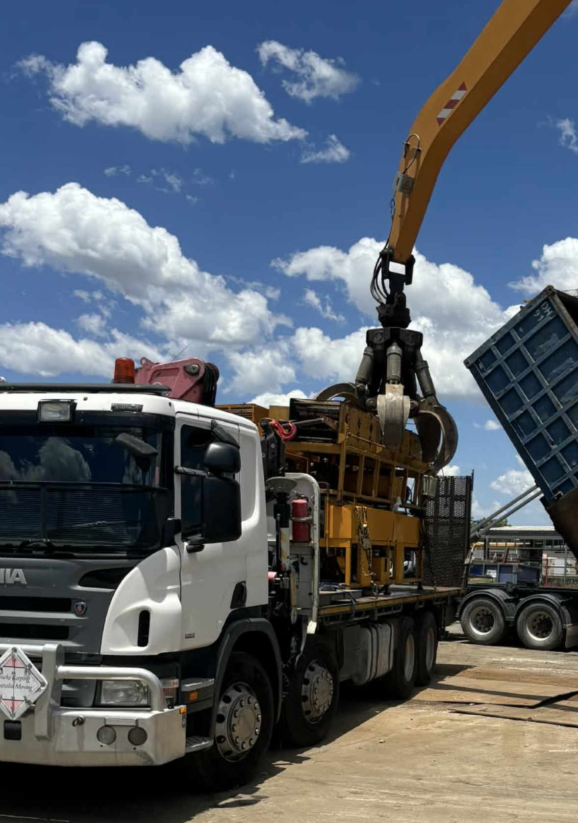A truck being loaded with scrap metal by a crane on a sunny day— Independent Scrap Metal Pty Ltd in South Lismore, NSW