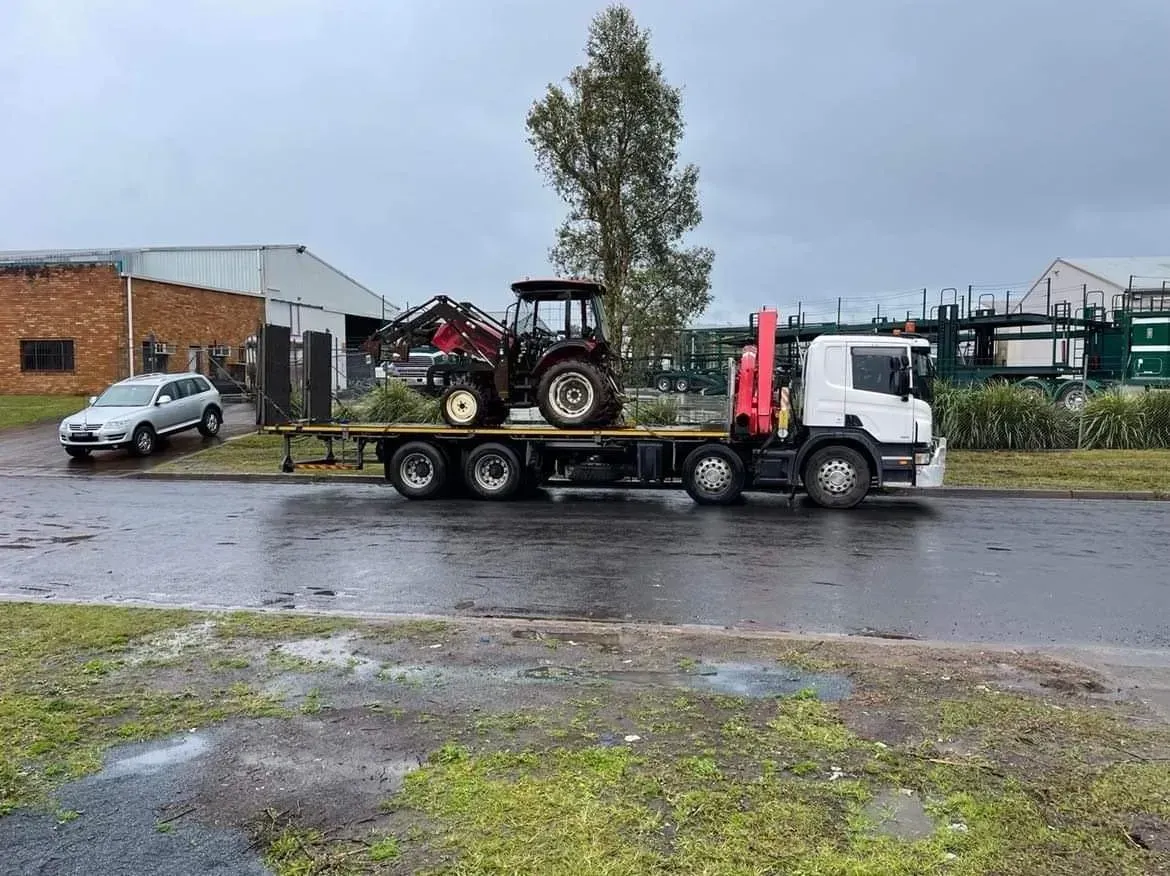 Truck With a Tractor Loaded on Its Flatbed — Independent Scrap Metal Pty Ltd in Tweed Heads, NSW