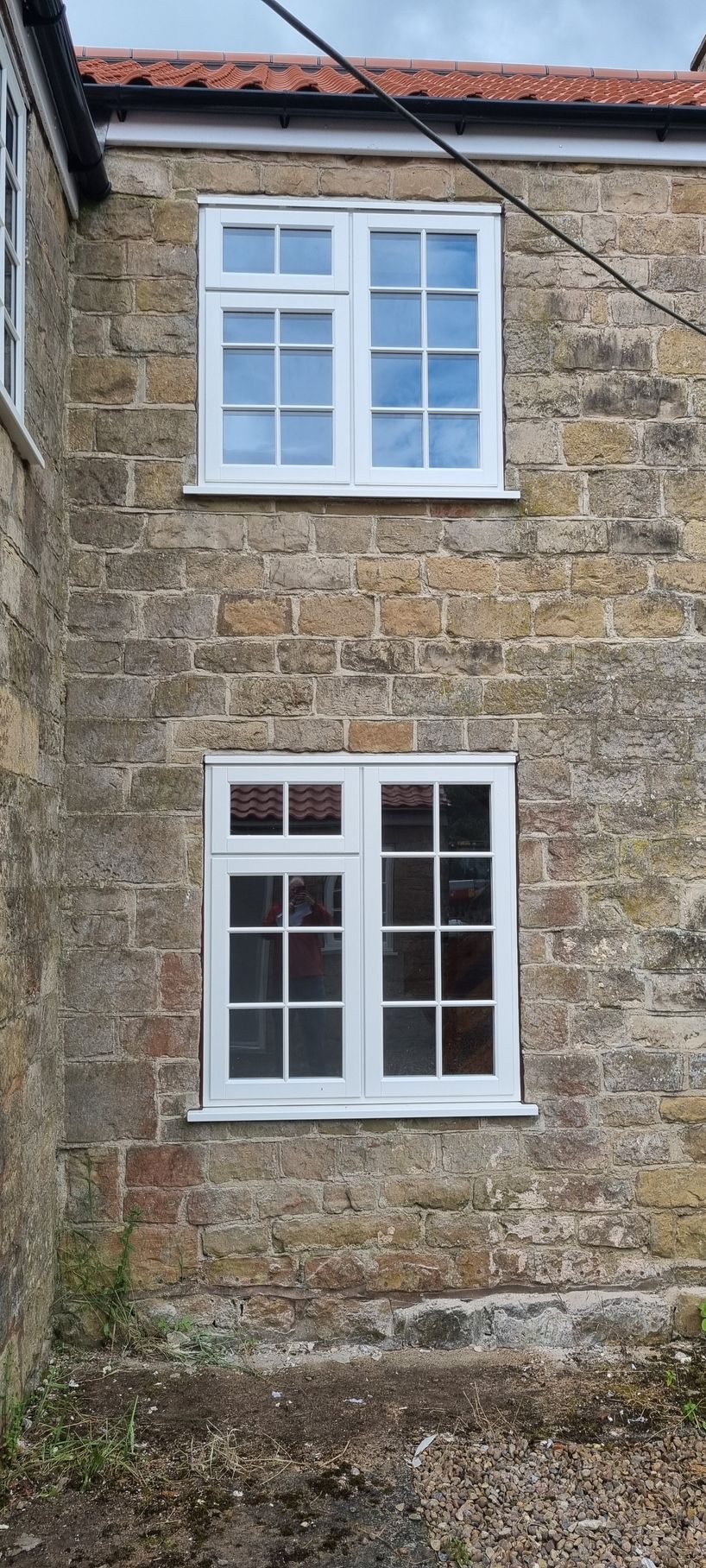 A window that has just been cleaned on a stone cottage.