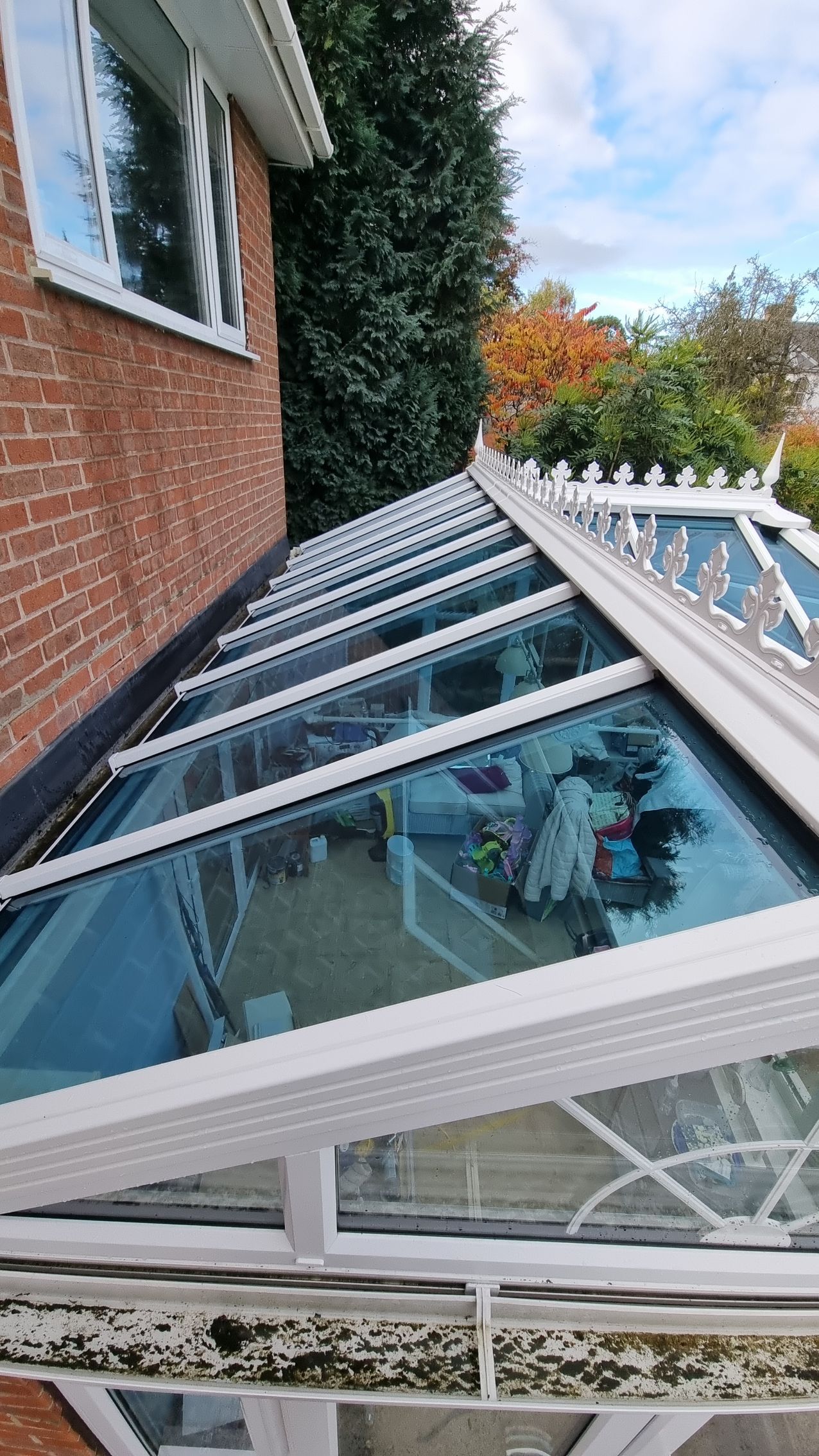 A large brick building with a tiled roof and many windows that need cleaning.