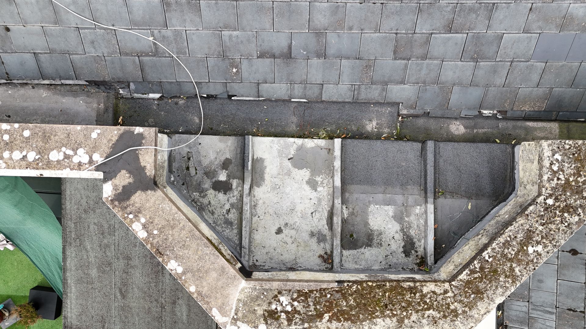 Drone roof survey showing top of flat roof bay window and slate tiles