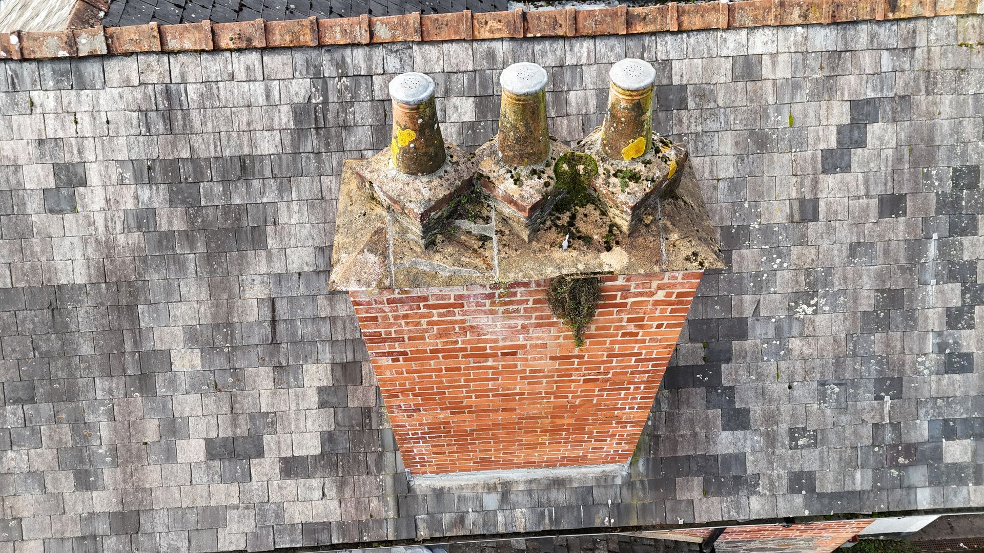 Drone roof survey showing slate tiles, ridge tiles and chimney stack