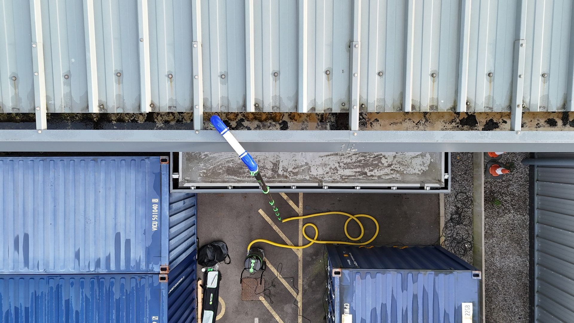 Aerial view of commercial box gutter being cleaned with Gutter Vacuum