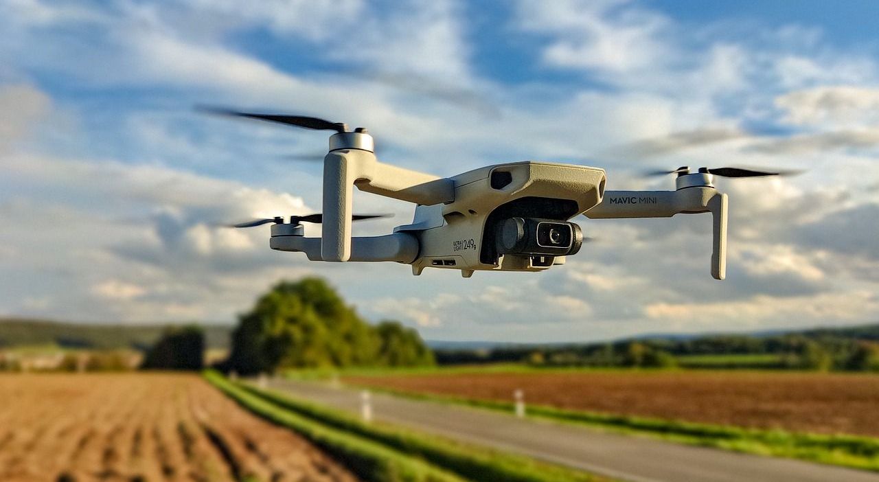 DJI Mini 249g Drone flying over farmland