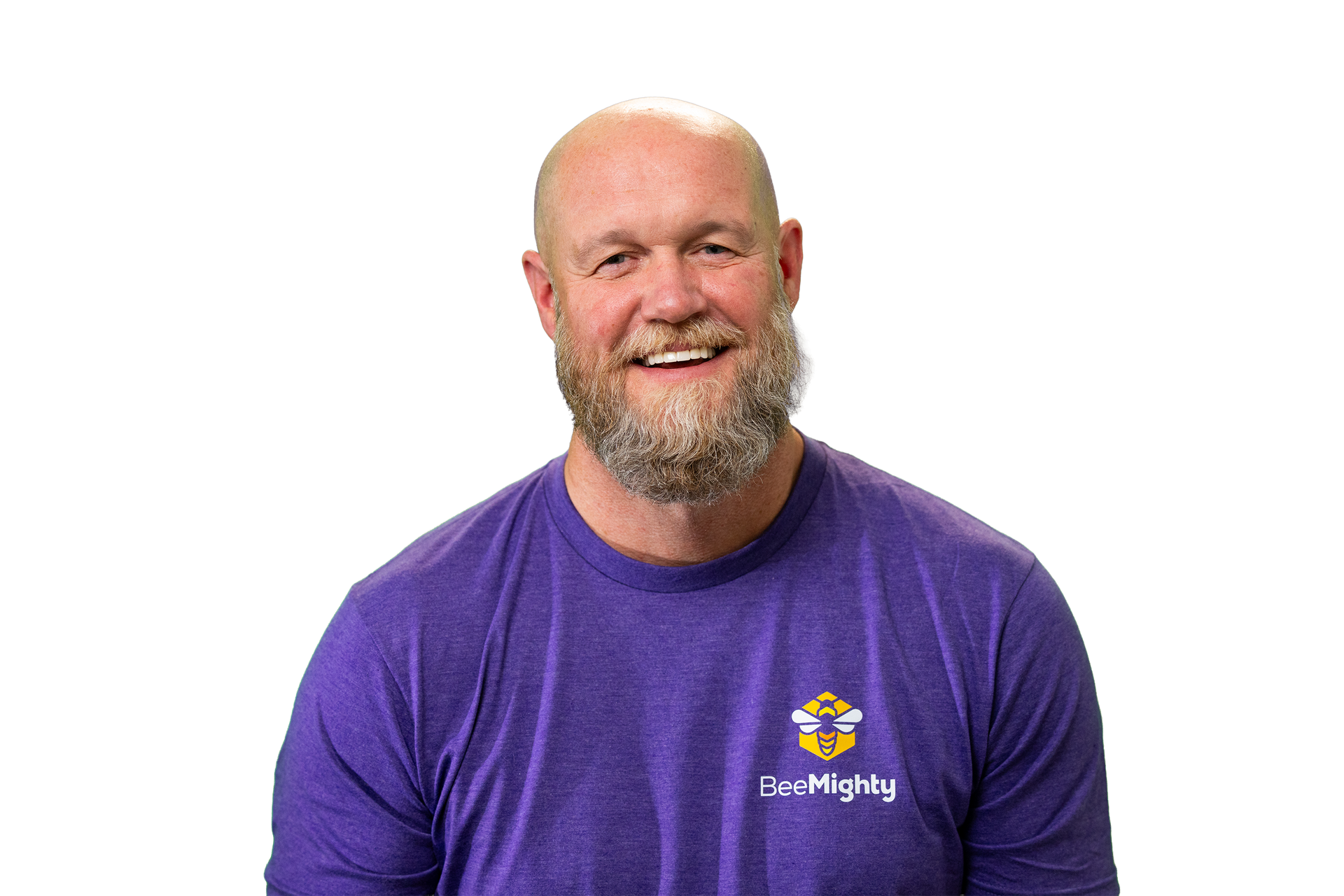 Man with a bald head and beard wearing a purple shirt, smiling against a white background.