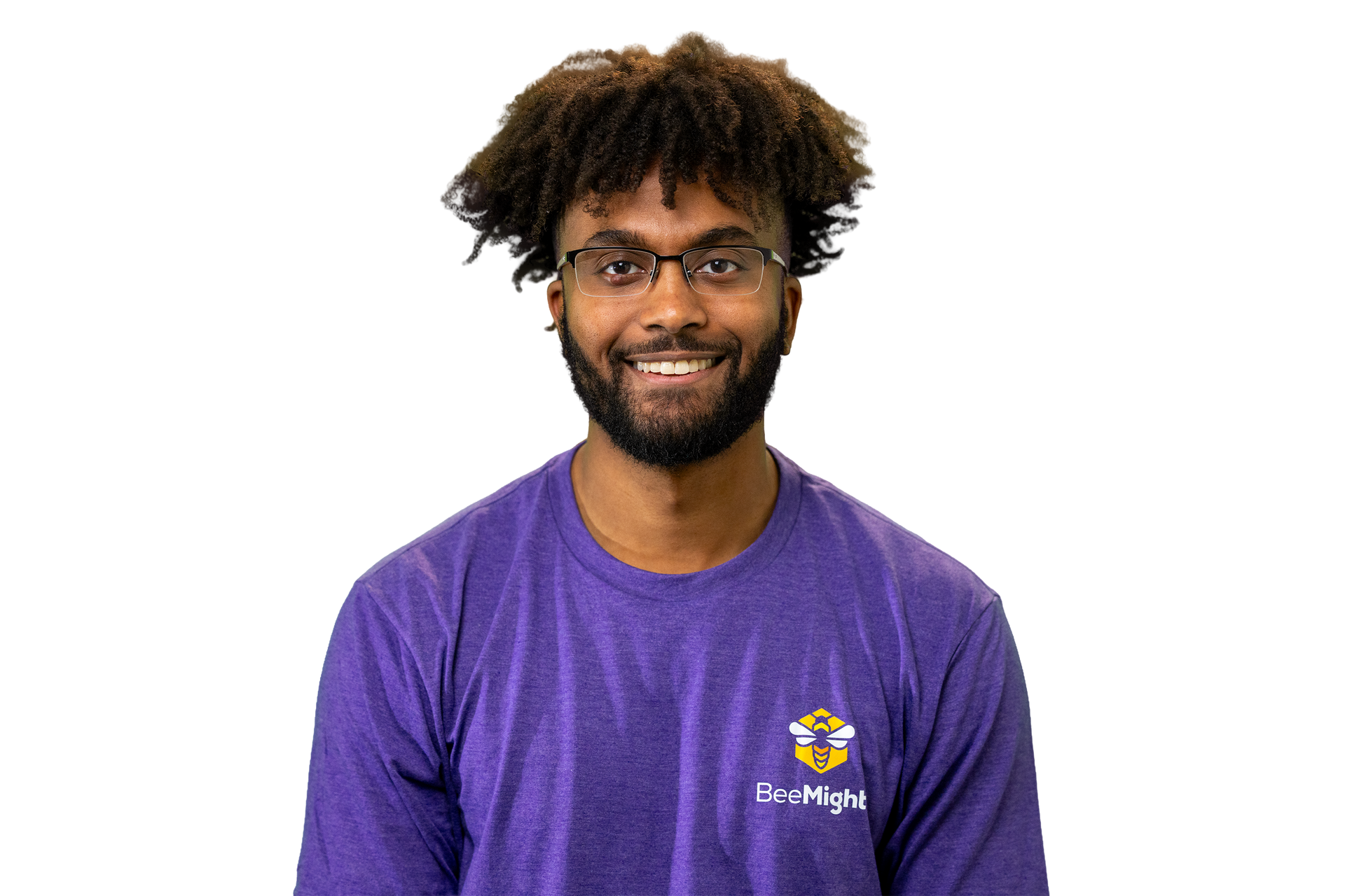 Man with glasses smiles, wearing a purple long-sleeve shirt. White background.