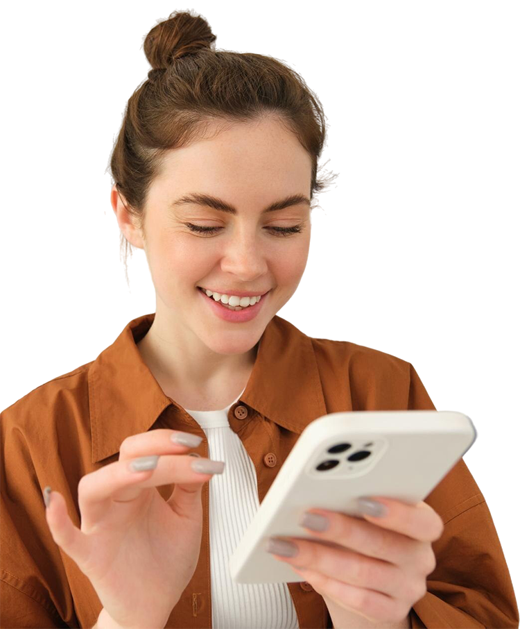 Woman with bun smiles while using smartphone. Wearing brown button-up over white top.