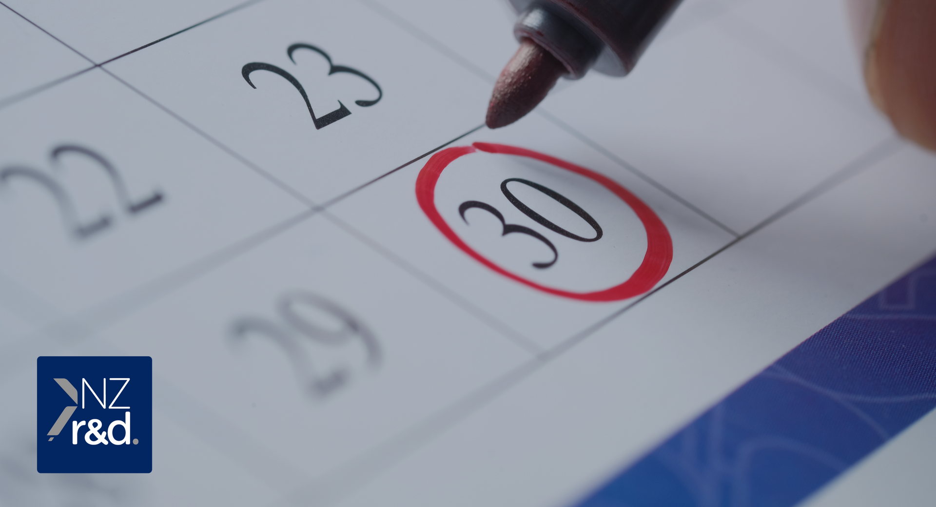 A person is drawing a red circle around the number 30 on a calendar